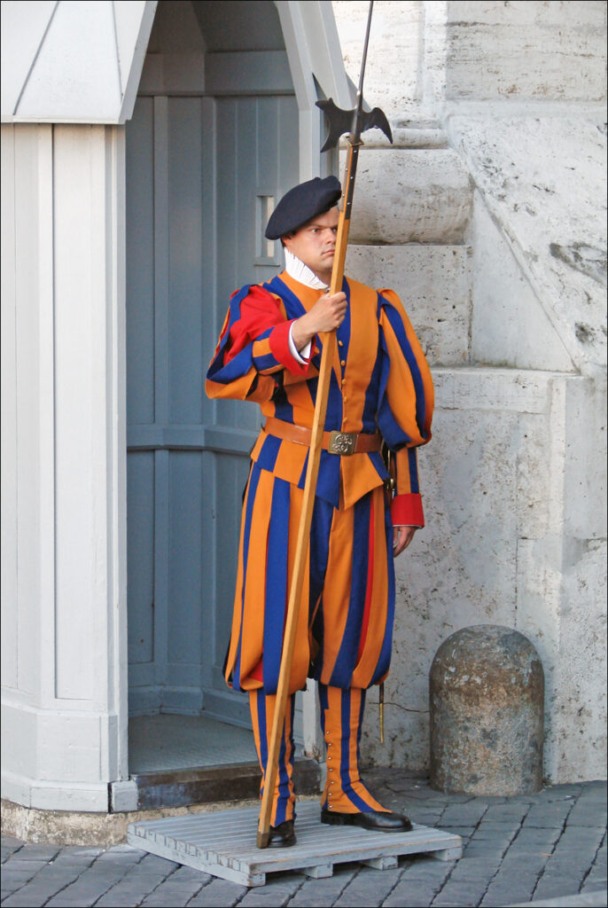 A member of the Pontifical Swiss Guard with halberd, 2011. Tricolor full dress uniform worn with black beret. Photo by Jean-Pierre Dalbéra.