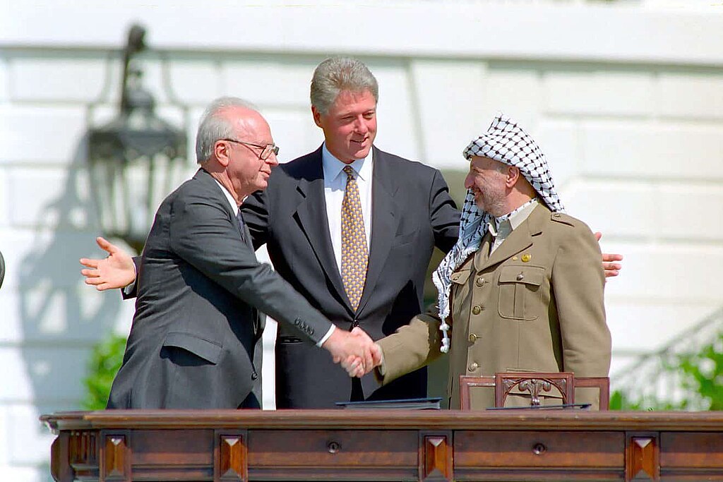 Israeli Prime Minister Yitzhak Rabin, U.S. President Bill Clinton, and Yasser Arafat at the Oslo Accords signing ceremony on 13 September 1993. Public domain. Israeli Prime Minister Yitzhak Rabin, U.S. President Bill Clinton, and Yasser Arafat at the Oslo Accords signing ceremony on 13 September 1993. Public domain.