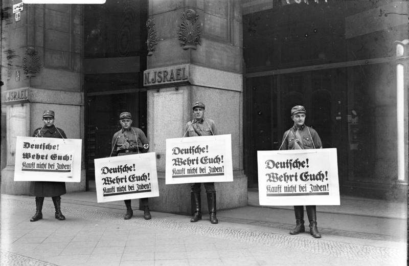 Nazi boycott of Jewish businesses, April 1933. The posters say "Germans! Defend yourselves! Don't buy from Jews!". Photo by German Federal Archive. Nazi boycott of Jewish businesses, April 1933. The posters say "Germans! Defend yourselves! Don't buy from Jews!". Photo by German Federal Archive.