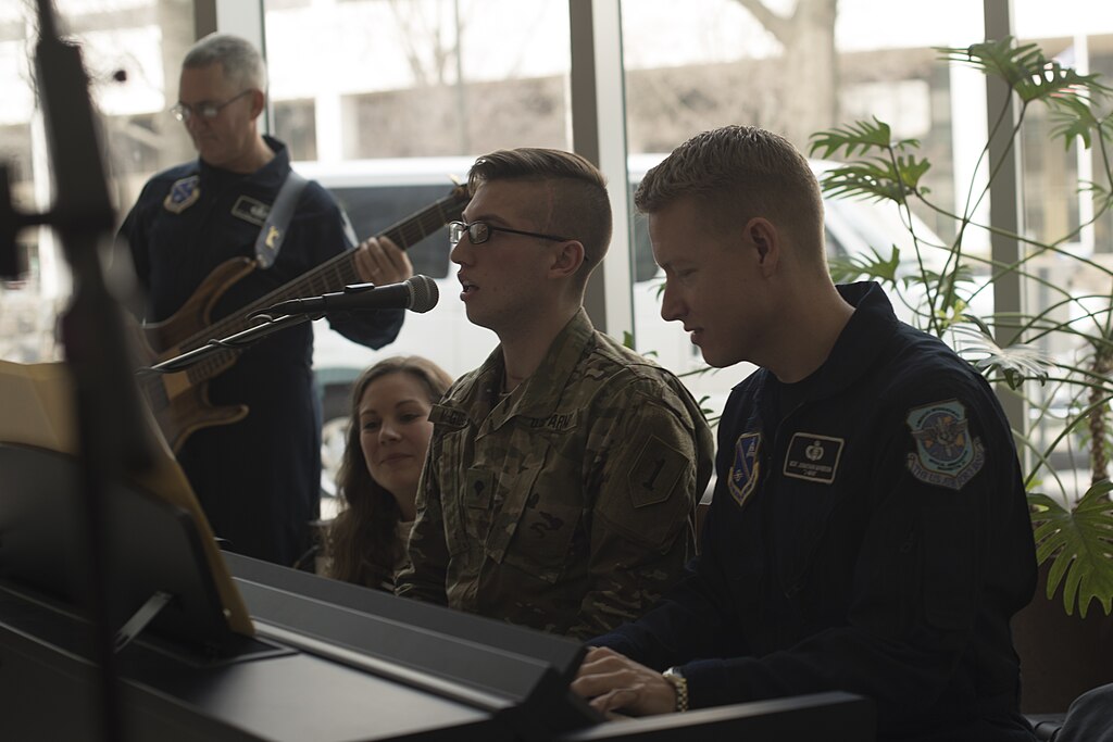 A military personnel practicing music therapy, with a music therapist. Public domain. A military personnel practicing music therapy, with a music therapist. Public domain.