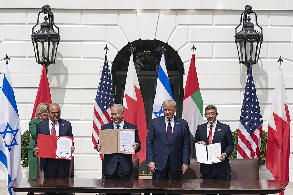 President Donald J. Trump, Minister of Foreign Affairs of Bahrain Dr. Abdullatif bin Rashid Al-Zayani, Israeli Prime Minister Benjamin Netanyahu and Minister of Foreign Affairs for the United Arab Emirates Abdullah bin Zayed Al Nahyan signs the Abraham Accords Tuesday, Sept. 15, 2020, on the South Lawn of the White House. Public domain. President Donald J. Trump, Minister of Foreign Affairs of Bahrain Dr. Abdullatif bin Rashid Al-Zayani, Israeli Prime Minister Benjamin Netanyahu and Minister of Foreign Affairs for the United Arab Emirates Abdullah bin Zayed Al Nahyan signs the Abraham Accords Tuesday, Sept. 15, 2020, on the South Lawn of the White House. Public domain.